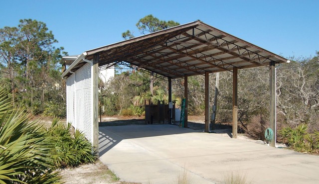 SPACIOUS COVERED RV LOT WITH A LARGE CONCRETE PAD