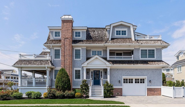 Spacious deck has ocean views as home is across the street from the beachblock.