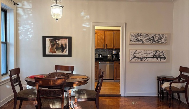 Spacious first floor of a 1920s brick row house on a quiet tree-lined street.