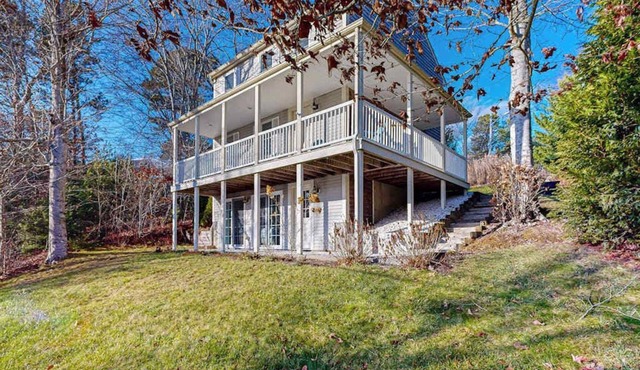 Spacious home close to Peters Pond Beach with porch, AC, W/D, & water view