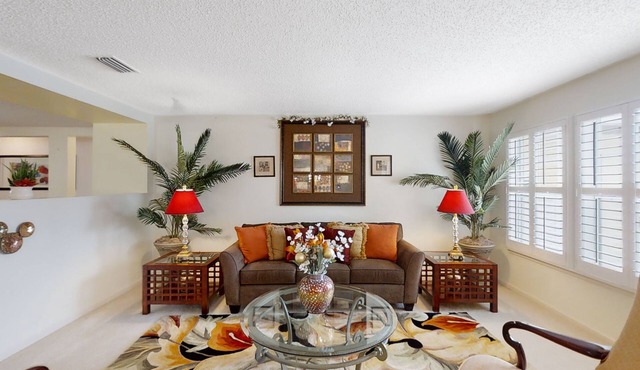 Spacious home with sunroom, patio, fireplace, & water views