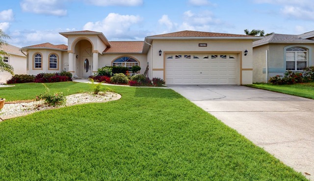 Spacious Lakefront Home with a Screened-In Pool in Exclusive Community