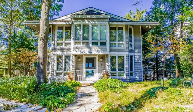 Spacious lakefront home with private beach, hot tub, fire table, & views