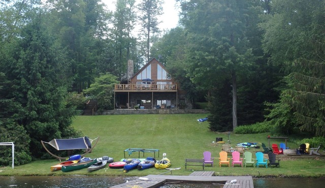 Spacious Lakefront Log Home with large lakefront porch, firepit
