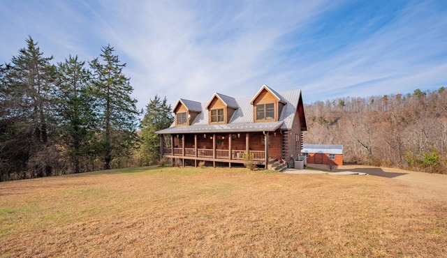 Spacious log cabin with game room, large deck, and a quiet serene location for relaxed family getaways.