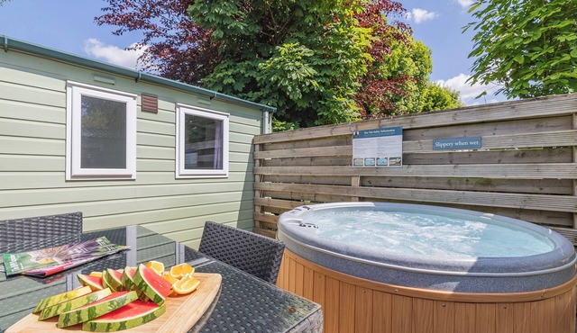 Spacious modern one-bedroom caravan exclusively for two adults with hot tub.