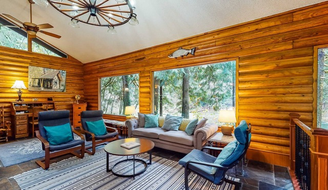 Spacious riverfront lodge with beach access, private hot tub & forest views
