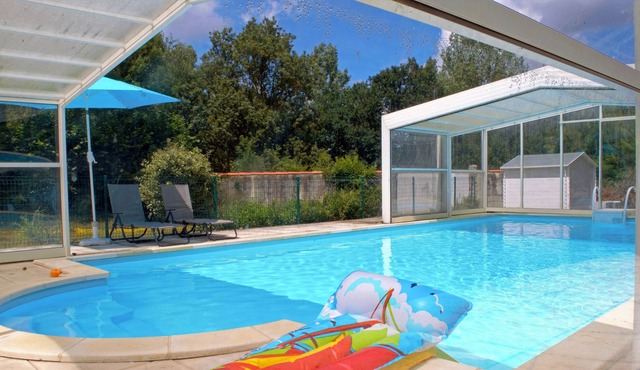 Spacious sunny three bedroomed gite with covered heated pool and river.