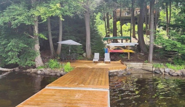 Spacious, waterfront home surrounded by trees with large dock & games room.