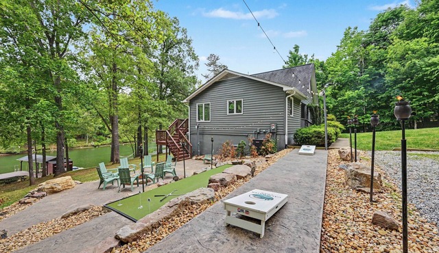 Spacious waterfront escape with screened porch, water slide, kayak, & games