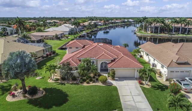 Spacious, waterfront home with dock, heated pool, and lanai