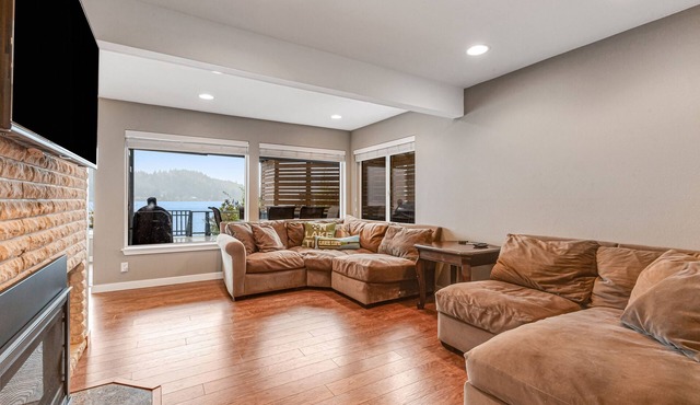 Sprawling lakefront property with kayaks, large deck, game table, & fireplace