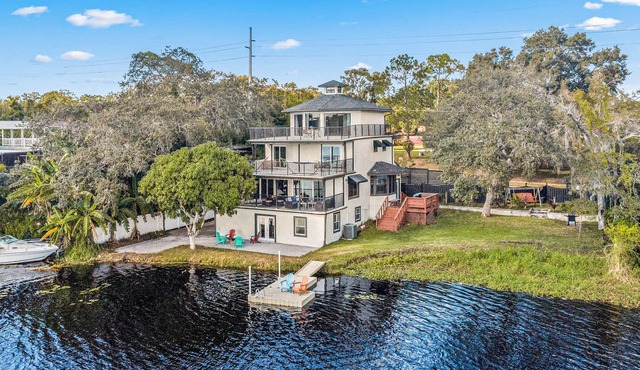Sprawling river view estate with game room, dock, kayaks, grill, & fishing gear