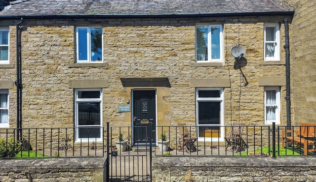 Stone-built double-fronted cottage positioned within the market place of Allendale.