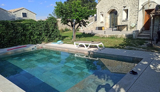 Stone house renovated in a contemporary style with garden and swimming pool.