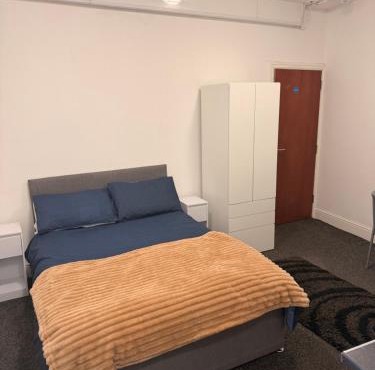 studio apartment with small kitchen and bathroom