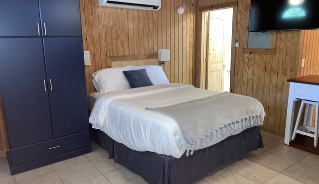 Studio cabin #2 with lake view, boat dock access, outdoor seating, and firepit.