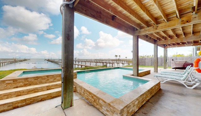 Stunning bay front home with fishing pier, large deck, & private pool