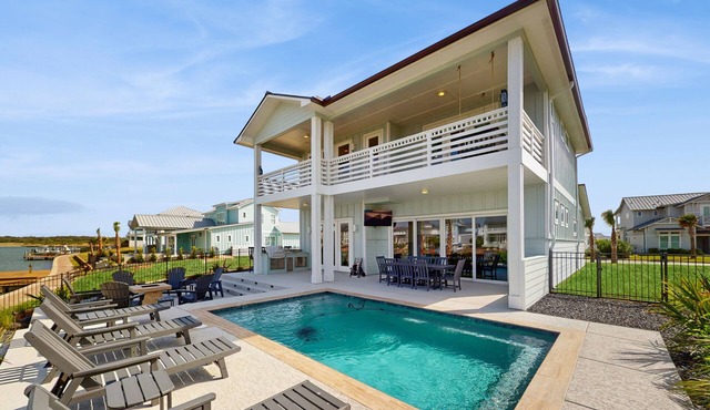 Stunning canal front home with private pool, fire pit, and boat dock