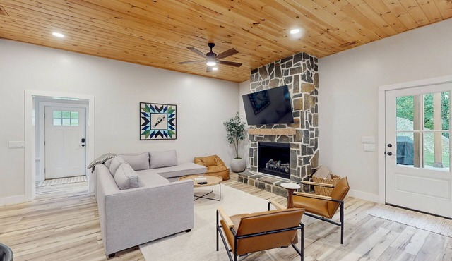 Stunning dog-friendly cottage with riverfront patio, hot tub, fire pit, & views