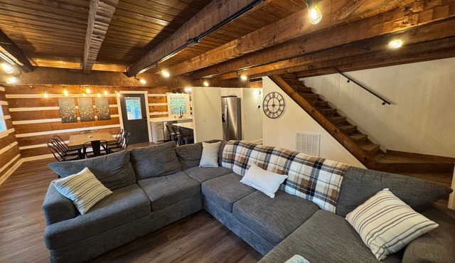 Stunning hand-hewn log cabin blending rustic charm with modern comfort. Minutes from Manchester's dining & shops, yet secluded enough to truly relax. Warm timber beams, cozy furnishings, smart TV & spacious living. 4 bedroom, sleeps 12.