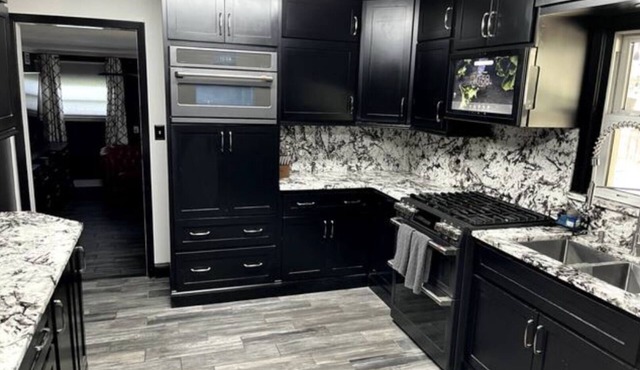 Stunning home with in ground pool, hot tub, bocce court, gourmet granite kitchen