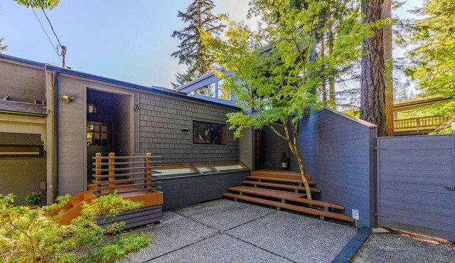 Stunning lakefront home with a private dock, balcony, grill, & a hot tub