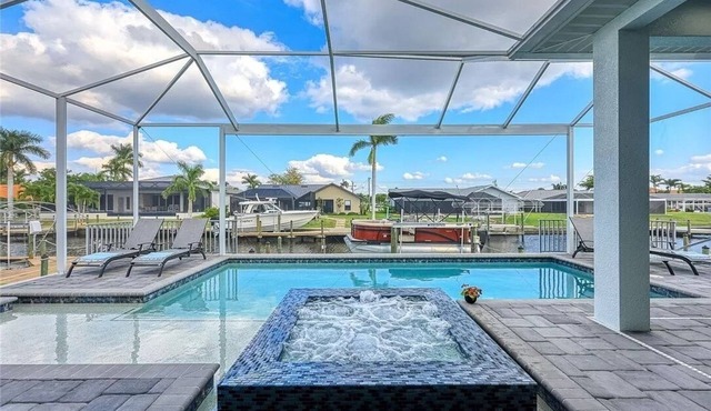 Stunning New Waterfront Luxury Villa with oversized Heated pool and Hot tub!