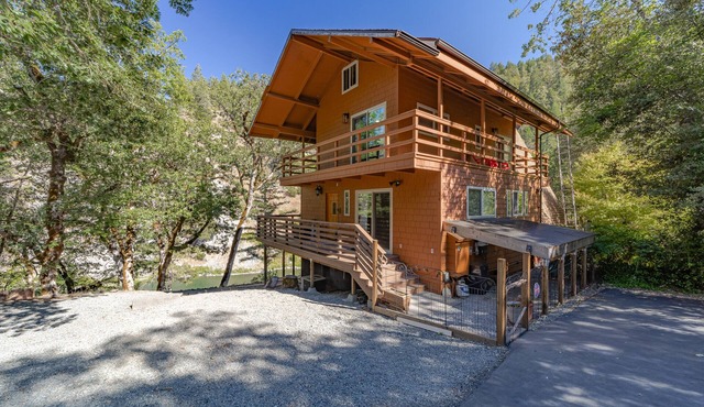 Stunning riverfront gem w/wraparound deck, beach access & game room