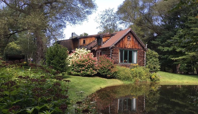 Stunning, Secluded Log Home Surrounded by Woods and Water