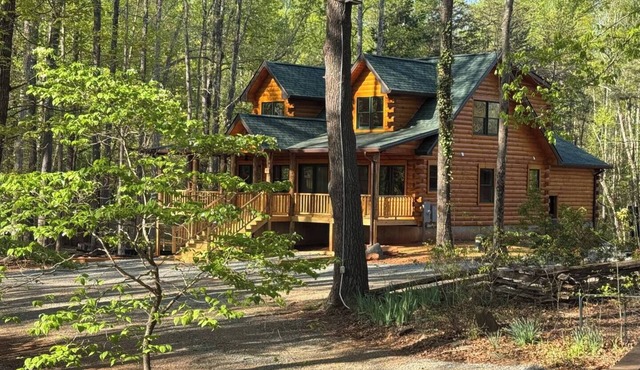 Stunning SML lakefront cabin: luxurious finishes, spacious rooms, wraparound deck, easy dock access. Family-friendly with toys, media room, serene views!