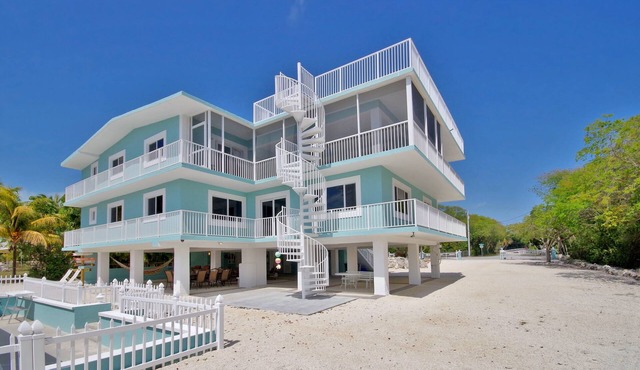 Stunning Three Level House on Key Largo Canal with a heated pool and roof deck.