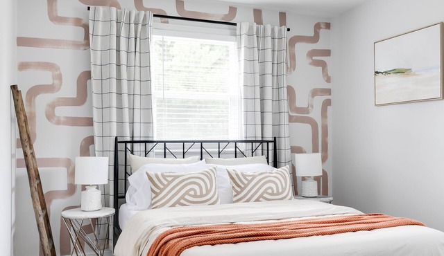 Stylish 4 bedroom house with outdoor dining and fenced backyard.