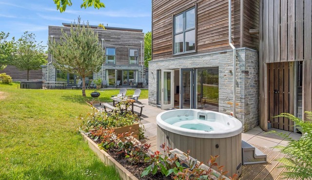 Stylish and contemporary pet friendly property featuring a wood-burning stove, patio hot tub and lar
