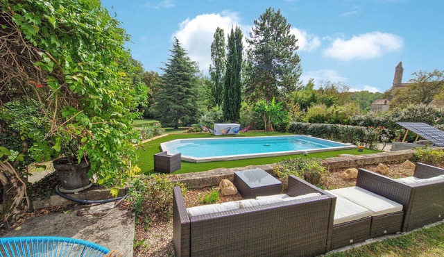 Stylish stone house with pool and wooded park.