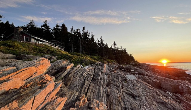 Sunrise Cottage. Relaxing waterfront deck on the rocky shore of Bailey Island.