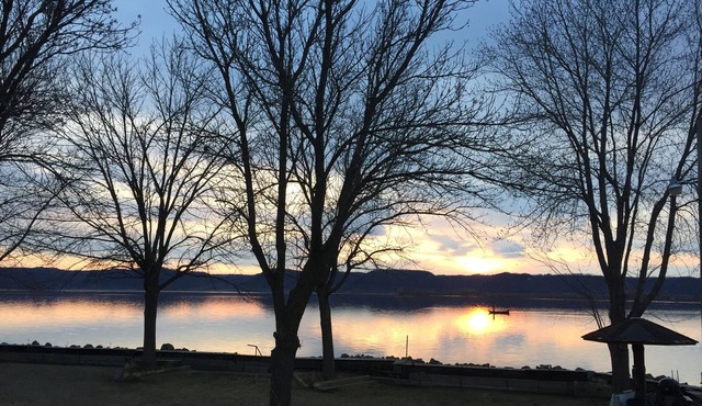 Sunset Waters: Serene Retreat on the Mississippi River Shoreline Fisher Friendly