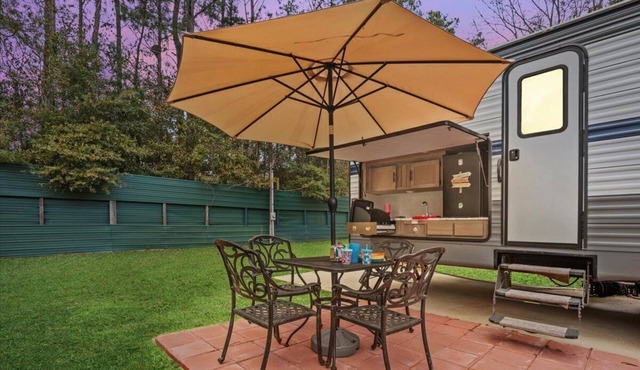 Super- fun camper with plenty of room for a full-size family, lots of comfy beds + full kitchen, bath, and separate bedroom for Mom & Dad. There's even a nice patio with outdoor kitchen and seating area for barbecues, bacon & eggs in the morning, et