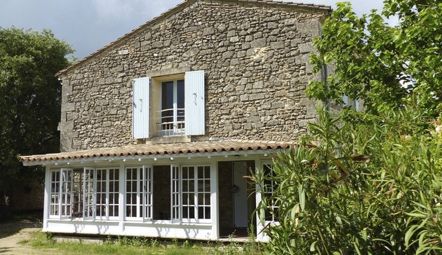 Superbly equipped apartment in old stone house with large pool and great view.