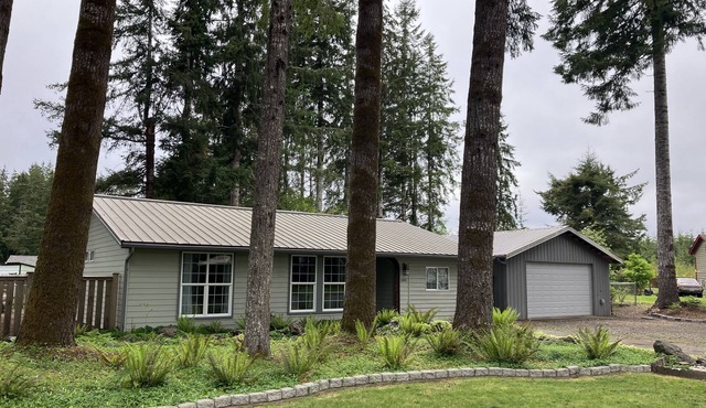Surrounded by trees, this 3-bedroom, fully stocked retreat sleeps 8.