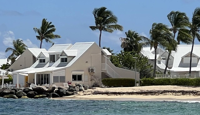 Sweet Home SXM Baie Nettlé Feet in the water on the beach