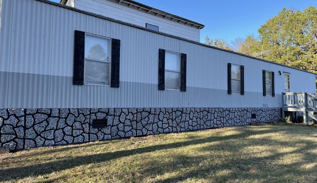 Terrific 2-bedroom mobile home with plenty of outdoor space to enjoy nature.