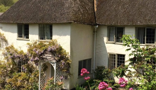 Thatched Devon longhouse, close to sea, with private indoor swimming pool.