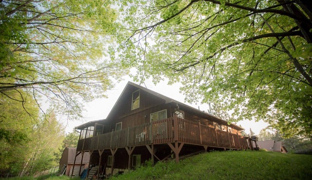 The Cedar House Is Uniquely Set In The Forest Surrounded By Decks And Porches.