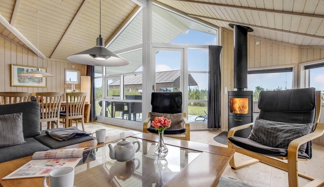 The cottage has an inviting kitchen-living room with a fireplace and a partially covered terrace.