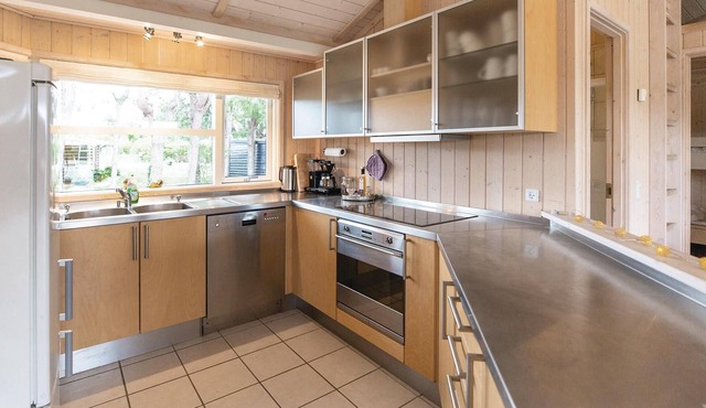 The cottage in Stillinge Strand has a kitchen open to the living room.