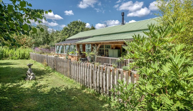 The Garden Room. Timber framed, light and airy accommodation with veranda.