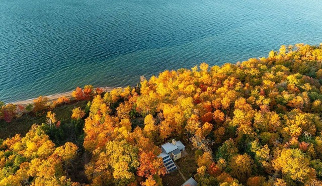 The Haven is a stunning architect designed home on Madeline island with views of the apostle islands by Wilder Co. Warm prairie style interiors, complete privacy, hidden beach access, wood fired sauna, luxury stay.