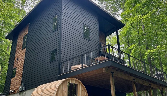 The Holiday House | Modern Wooded Retreat Near TC & Trails | Sauna