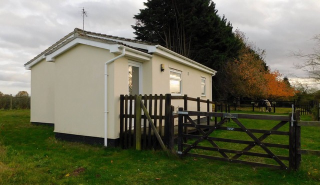 The Paddocks - a bungalow situated in a rural village surrounded by fields and horses